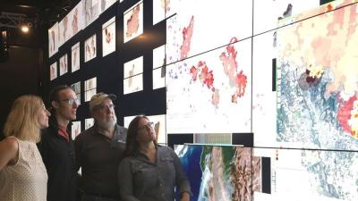 Wildfire Science & Technology Commons staff looking at screen